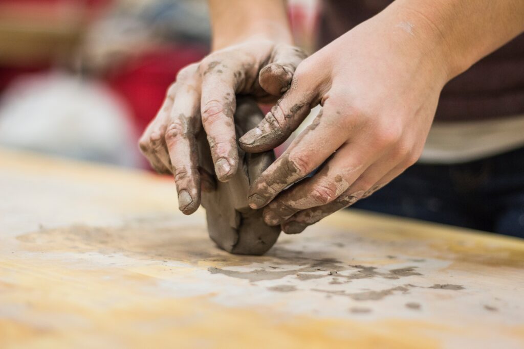 hands working with clay